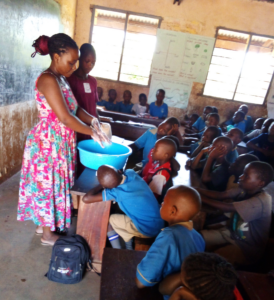 Judith, centre coordinator, demonstrates the recommended way of washing hands.
